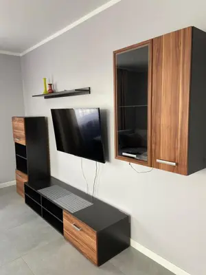 a living room with a tv and a cabinet at Energylandia Zator noclegi apartament pokoje do wynajęcia in Polanka Wielka