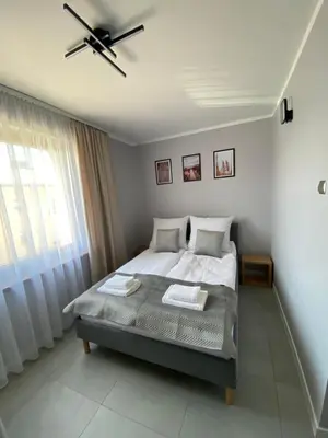 a bedroom with a bed and a ceiling fan at Energylandia Zator noclegi apartament pokoje do wynajęcia in Polanka Wielka