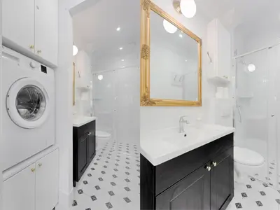 a white bathroom with a sink and a washing machine at Tyzenhauz Apartments Wawel in Kraków
