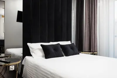 a bedroom with a bed with two pillows on it at City of the Kings - Onyks Apartment in Kraków