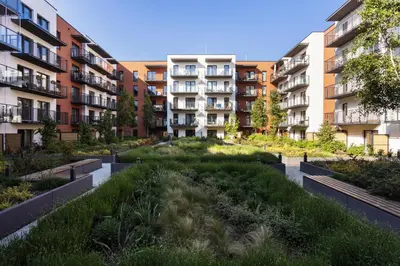 a courtyard in an apartment building with a garden at City of the Kings - Onyks Apartment in Kraków