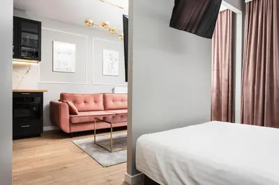 a hotel room with a bed and a couch at City of the Kings - Onyks Apartment in Kraków