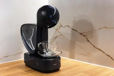 a black blender sitting on a table with a glass at City of the Kings - Onyks Apartment in Kraków