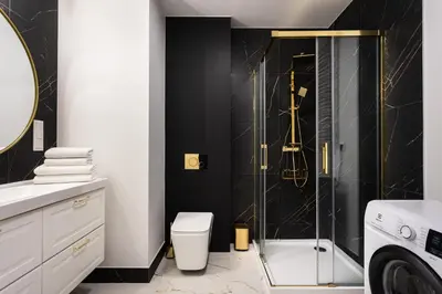 a bathroom with a shower and a toilet and a sink at City of the Kings - Onyks Apartment in Kraków