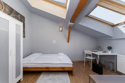 a small bedroom with a bed and a desk at Flat With Cosy Attic - Castle Round the Corner - by Upstairs in Kraków