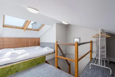 a room with a bunk bed and a ladder at Flat With Cosy Attic - Castle Round the Corner - by Upstairs in Kraków