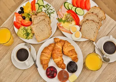 a table topped with plates of breakfast foods and coffee at Flat With Cosy Attic - Castle Round the Corner - by Upstairs in Kraków