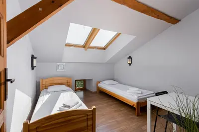 two beds in a room with white walls and wooden floors at Flat With Cosy Attic - Castle Round the Corner - by Upstairs in Kraków
