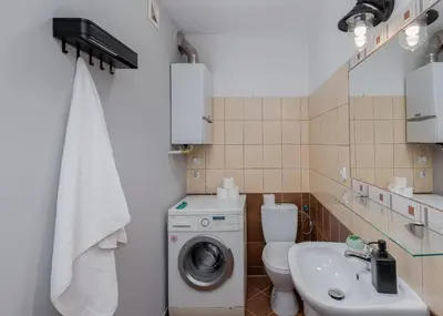 a bathroom with a washing machine and a sink at Flat With Cosy Attic - Castle Round the Corner - by Upstairs in Kraków