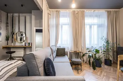 a living room with a couch and some windows at Charming apartment in the Old Town in Kraków