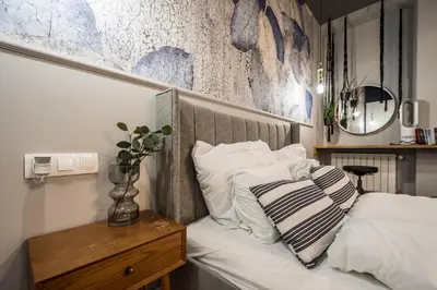a bed with white sheets and pillows on it at Charming apartment in the Old Town in Kraków