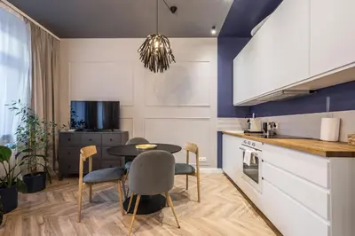 a kitchen with a table and chairs in a room at Charming apartment in the Old Town in Kraków