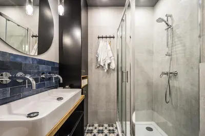 a bathroom with a sink and a shower at Charming apartment in the Old Town in Kraków