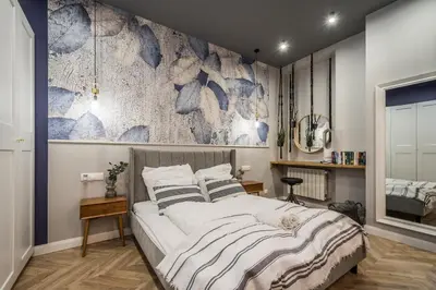 a bedroom with a large bed and a wall mural at Charming apartment in the Old Town in Kraków
