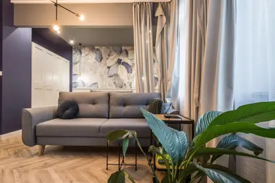 a living room with a couch and a wall at Charming apartment in the Old Town in Kraków