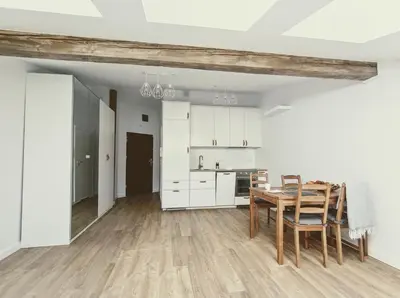 a kitchen and dining room with a table and chairs at 34m2 apartament w centrum Krakowa in Kraków