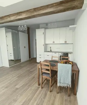 a kitchen and dining room with a table and chairs at 34m2 apartament w centrum Krakowa in Kraków
