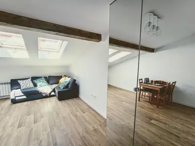 a living room with a couch and a table at 34m2 apartament w centrum Krakowa in Kraków