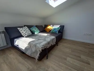 a couch with pillows on it in a living room at 34m2 apartament w centrum Krakowa in Kraków