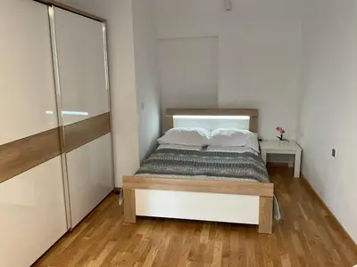 a small bedroom with a bed and a closet at Apartment na Zamkowej in Kraków