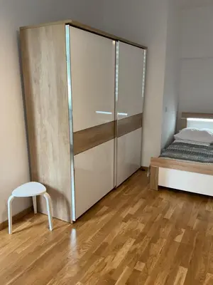 a bedroom with a sliding glass door next to a bed at Apartment na Zamkowej in Kraków