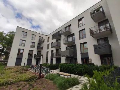 an apartment building with bikes parked outside of it at Nowoczesny apartament dla par in Kraków