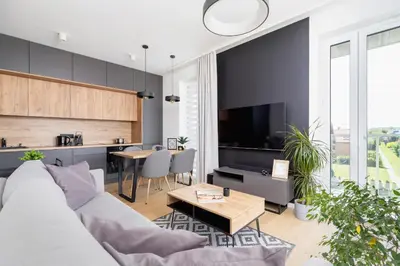a living room with a couch and a table at Modern & Spacious Apartment with Air Conditioning & Parking by Renters Prestige in Kraków