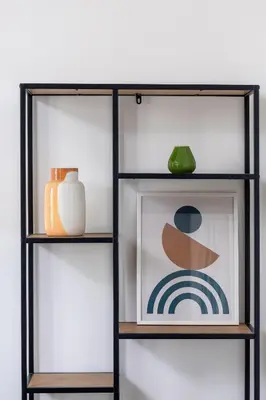 a shelf with a picture and a green vase at Modern & Spacious Apartment with Air Conditioning & Parking by Renters Prestige in Kraków