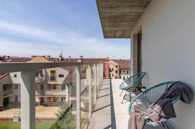 a balcony with two chairs and a view of a city at Modern & Spacious Apartment with Air Conditioning & Parking by Renters Prestige in Kraków