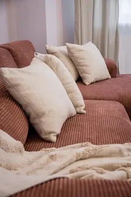 a pile of pillows sitting on a bed at Koletek 7 Apartment near the Wawel Castle in Kraków