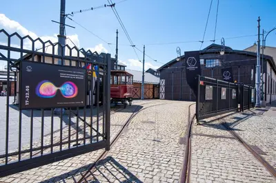 a gate at a train station with a trolley at City Lights Skawińska in Kraków