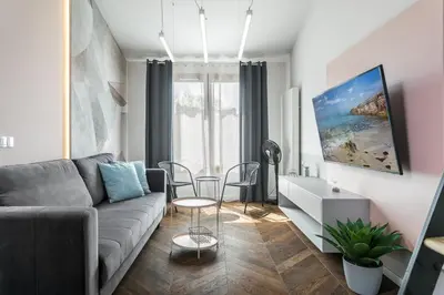 a living room with a couch and a table at Premium Apartment in Kossak Residence in Kraków