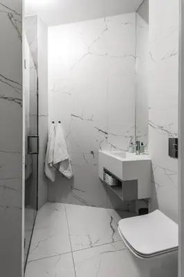 a white bathroom with a toilet and a sink at Premium Apartment in Kossak Residence in Kraków