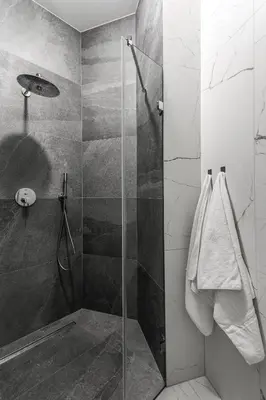 a shower with a glass door in a bathroom at Premium Apartment in Kossak Residence in Kraków