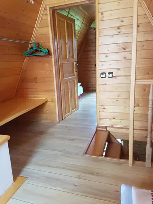 an attic room with an open door in a wooden cabin at LESNA CHATA - jestesmy 15km od Energylandii, domek wolnostojacy, Beskid Maly in Zagórnik