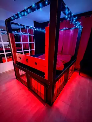 a wooden bunk bed with lights on it in a room at BDSM Elysium Playsuite in Kraków