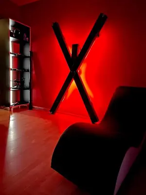 a red room with a chair and a red wall at BDSM Elysium Playsuite in Kraków