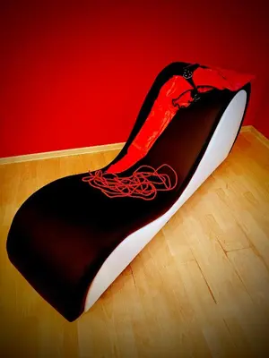 a black and red rug on a wooden floor at BDSM Elysium Playsuite in Kraków