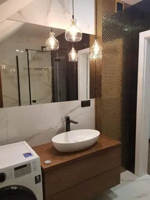 a bathroom with a sink and a washing machine at Mieszkanie do wynajęcia in Stróża