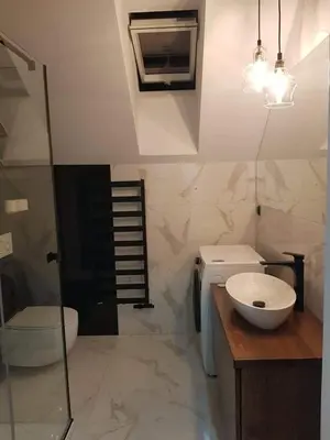 a bathroom with a sink and a toilet and a shower at Mieszkanie do wynajęcia in Stróża