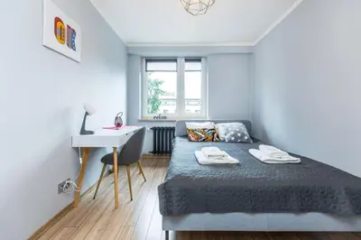 a small bedroom with a bed and a desk at Serene Apartment in the City Center - by Upstairs in Kraków