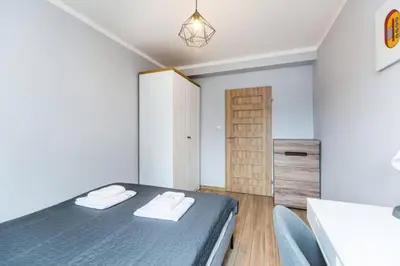 a bedroom with a bed and a table and chairs at Serene Apartment in the City Center - by Upstairs in Kraków