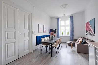 a kitchen and dining room with a table and chairs at Urban Nest Apartments Gertrudy 7 in Kraków