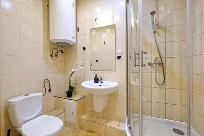 a bathroom with a toilet and a shower and a sink at Urban Nest Apartments Gertrudy 7 in Kraków