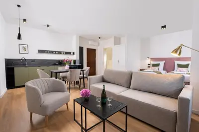a living room with a couch and a table at Rajska Residence in Kraków