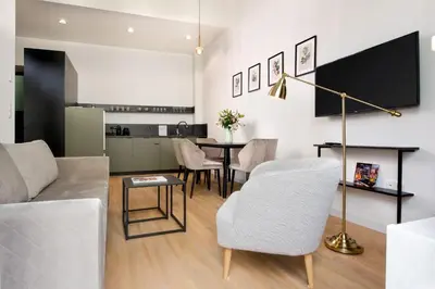 a living room with a couch and a table at Rajska Residence in Kraków