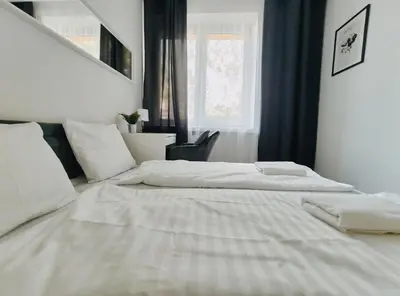 a white bed in a room with a window at Spasowskiego 2 by Homeprime in Kraków