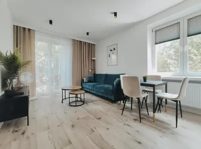 a living room with a blue couch and a table at Spasowskiego 2 by Homeprime in Kraków