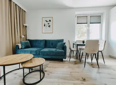 a living room with a blue couch and a table at Spasowskiego 2 by Homeprime in Kraków
