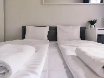 a bed with white sheets and pillows on it at Spasowskiego 2 by Homeprime in Kraków